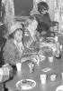 Isabel Doucette at table with unknown. Terry Marshall at end of table.(Roy Gould Collection)